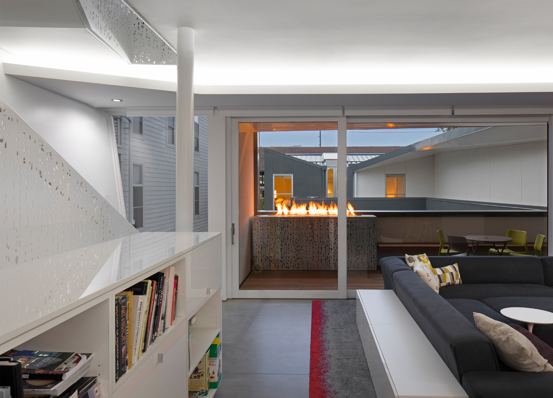 Living area opening to courtyard with linear fire feature