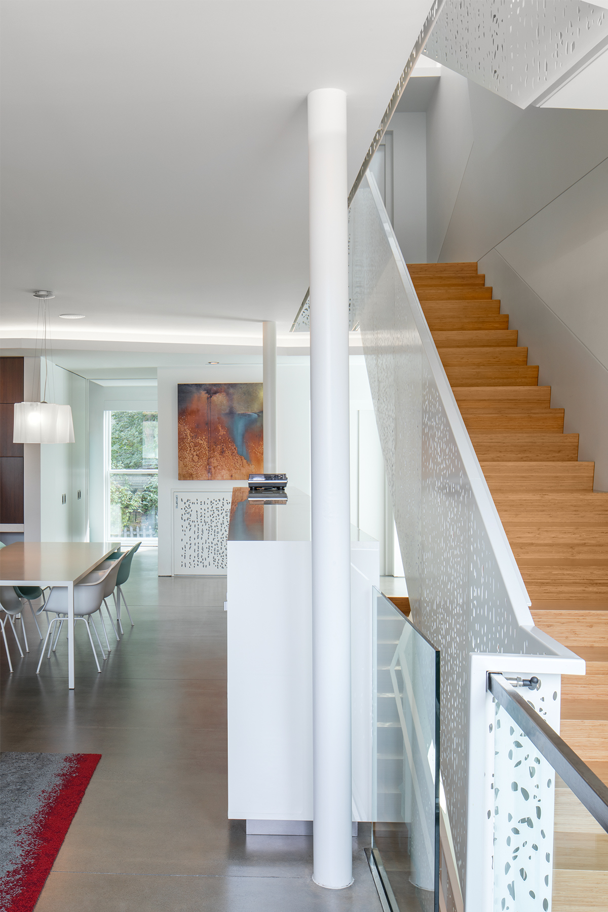 Glass-walled stairway at the heart of the residence